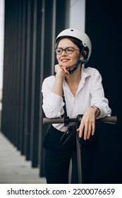 Young Business Woman Riding Electro Scooter By Ofice Center