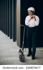 Young Business Woman Riding Electro Scooter By Ofice Center