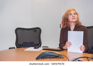 Young Business Woman Shuffling Papers And Thinking