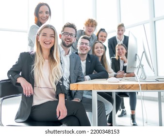 young business woman sitting in front of a big business team - Shutterstock ID 2200348153