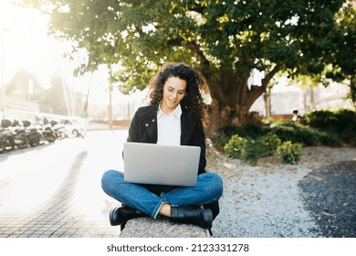 Young Business Woman, Sitting On The Street, Using A Laptop