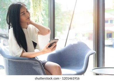young business woman sitting at table in office feeling tired and stressed, business concept