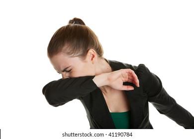 A young business woman, sneezing into her sleeve to prevent spreading germs.  Shot on white background. - Powered by Shutterstock