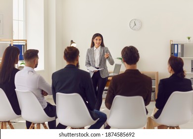 Young Business Woman Speaker Making Presentation Or Training For Group Of Business Office Workers In Modern Company Interior. Presentation, Training, Lecture For Business Concept