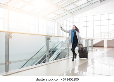 Young Business Woman With Suitcase Running To Catch The Plane Or Train In Before It Leaves The Station Without Her.