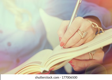 Young Business Woman Taking Notes On A Meeting