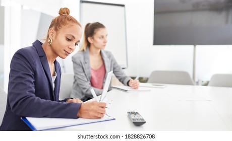 Young Business Woman Is Taking Notes In A Meeting Or Workshop