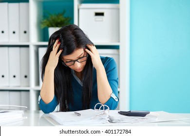 Young business woman under stress with head in hands