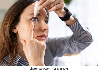 Young business woman uses eye drops for eye treatment. Redness, Dry Eyes, Allergy and Eye Itching