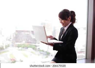 Young Business Woman Using Computer  In Her Hotel Room