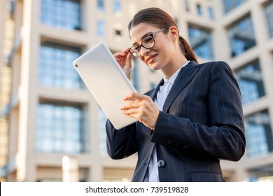 Young Business Woman Using Her Tablet Computer Outside.