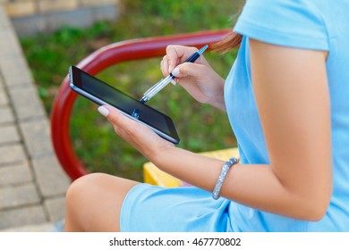 Young business woman using tablet in park