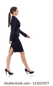 young business woman walking. She is smiling and looking away from the camera isolated over white background