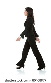 Young Business Woman Is Walking. She Is Smiling And Looking Away From The Camera Isolated Over White Background