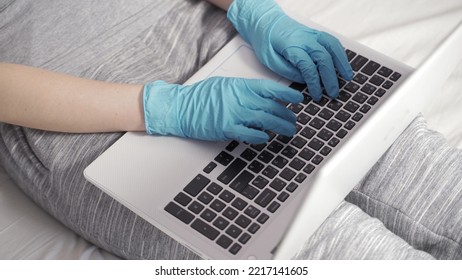 Young Business Woman Wears Medical Face Mask Gloves Working On Laptop Computer Sitting At Home Office Desk. Freelancer Doing Remote Job On Coronavirus Covid 19 Quarantine Concept. Close Up View