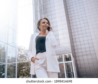 Young Business Woman In White Pantsuit