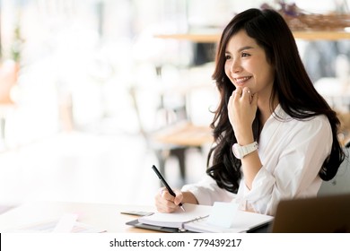 Young business woman working happily inthe office
