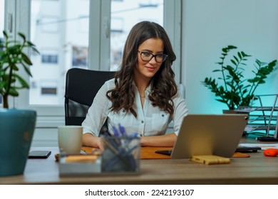 Young business woman working at her desk at her down town office, she's a paralegal working on a new case - Shutterstock ID 2242193107