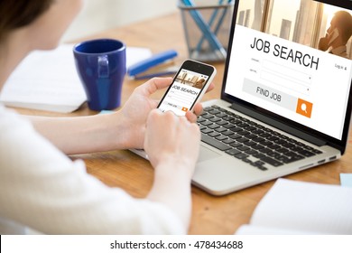 Young business woman working in office interior, searching for job online. Female looking for job using web service on smartphone. Close-up of hands holding phone. HR, recruitment, career concept - Powered by Shutterstock