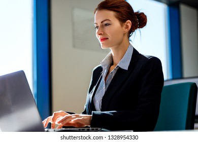Young business woman working on laptop in the office. - Shutterstock ID 1328954330