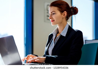Young business woman working on laptop in the office. - Shutterstock ID 1328954336