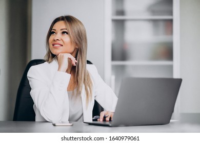 Young business woman working on laptop in an office - Shutterstock ID 1640979061