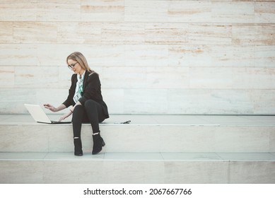 Young Business Woman Working On Her Notebook Computer Outside