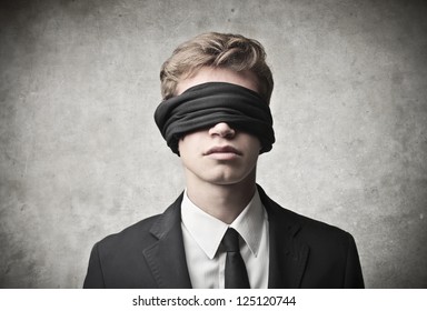 Young businessman blindfolded
