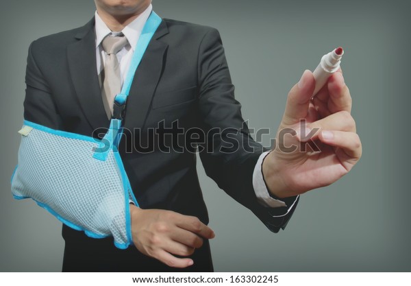 young businessman with broken hand wearing an arm\
brace, series