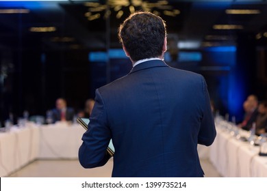 Young businessman at business conference room with public giving presentations. Audience at the conference hall. Entrepreneurship club. - Shutterstock ID 1399735214