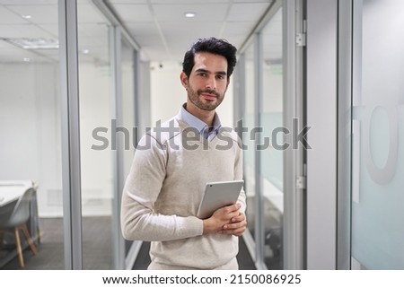 Young businessman as a business start-up founder using tablet computer in the office