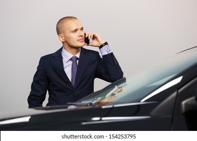 Young Businessman Calling On The Phone At The Car