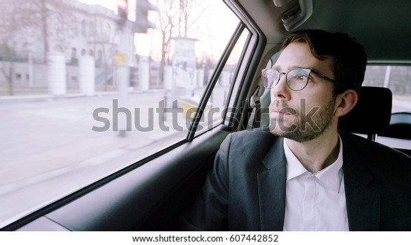 Young\
Businessman in the Car Using a Tablet\
Computer