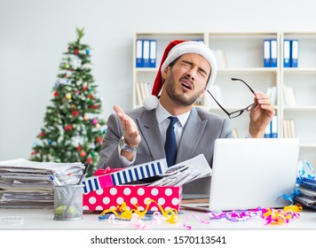 Young Businessman Celebrating Christmas In The Office