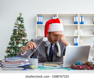 Young Businessman Celebrating Christmas In The Office