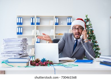 Young Businessman Celebrating Christmas In The Office