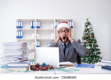 Young Businessman Celebrating Christmas In The Office