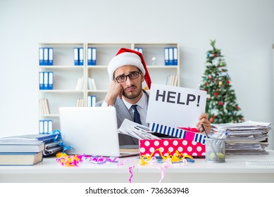 Young Businessman Celebrating Christmas In The Office