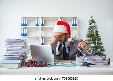 Young Businessman Celebrating Christmas In The Office