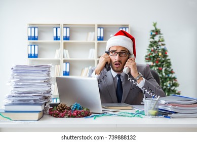 Young Businessman Celebrating Christmas In The Office