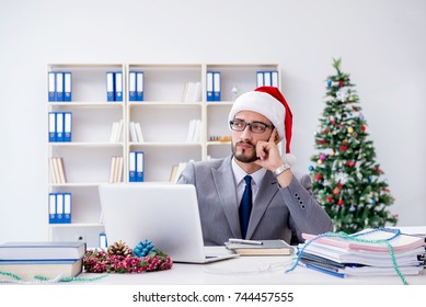 Young Businessman Celebrating Christmas In The Office