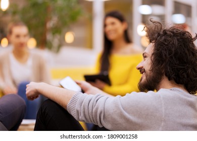 Young Businessman With Clumsy Hair On A Creative Meeting With Colleagues In Modern Office Space