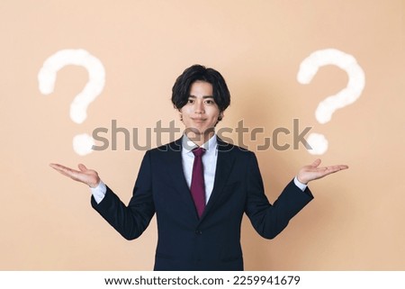 Young businessman comparing two things. Stockfoto © 