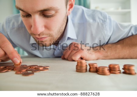 Young businessman counting coins