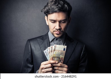 Young businessman counting money