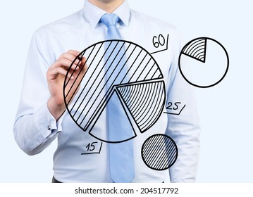 Young businessman is drawing pie charts as a metaphor of business development activity and implementation of new ideas. - Powered by Shutterstock