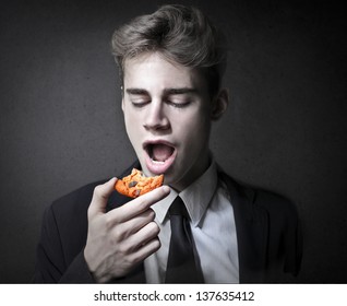 young businessman eating cookie
