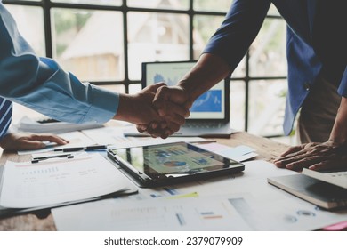 Young businessman and financial representative shaking hands after a budget deal for business expansion and investment in a village construction project real estate financial concept.