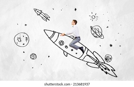 Young Businessman Flying In Sky On Drawn Rocket