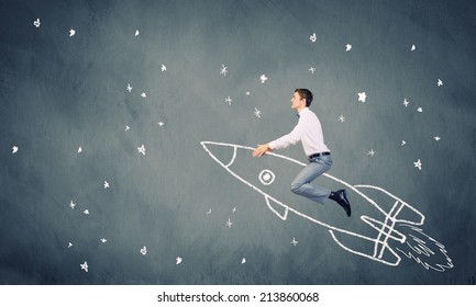 Young Businessman Flying In Sky On Drawn Rocket